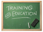 Picture of a chalkboard, chalk, and eraser. It says:
Training AND Education
