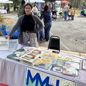 Tri County Community Network Celebrates Spring Initiatives and Community Growth.
Female standing behind a table with books on it.